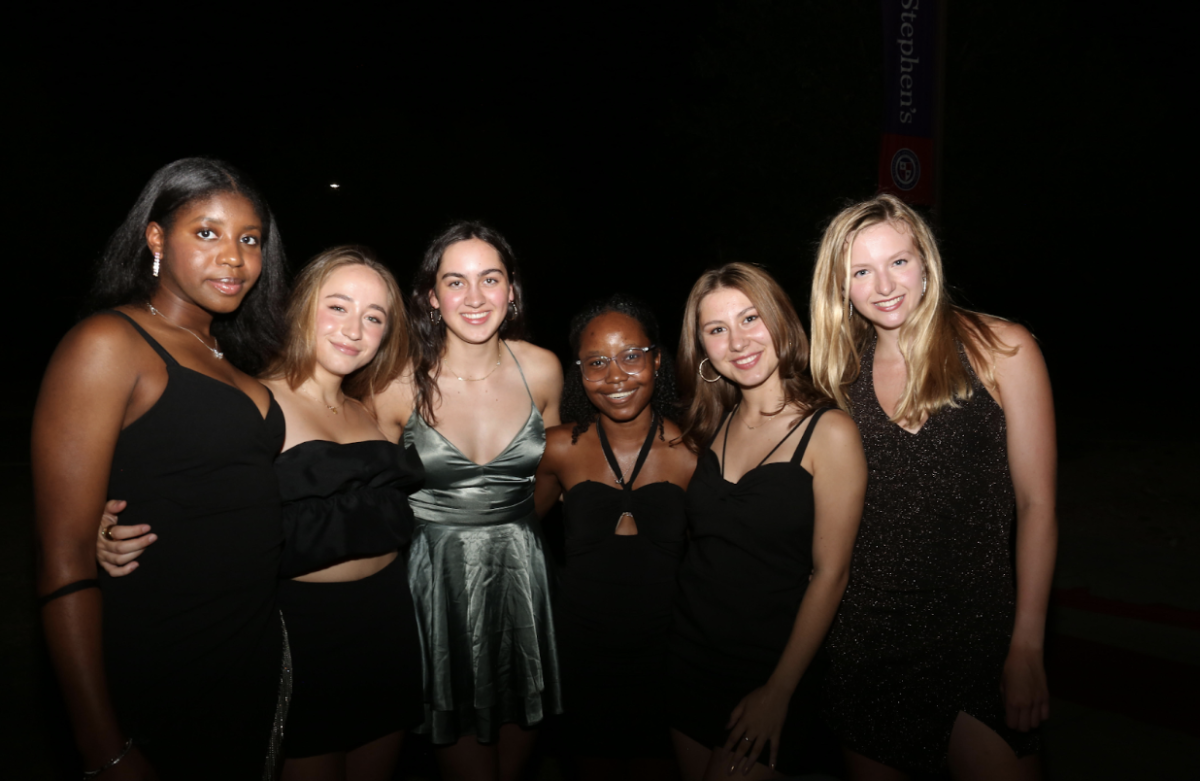 Left to right: Kamsi Mba, Eva Díaz Mirón Olloqui, Maeve Kalyan, Kelly Fairman, Andrea Munch, Jocelyn Hoenicke AKA Joss the Boss.

These seniors attended their last fall dance with style! Just like the guys, these girls bring both dark and bright—this time, sparkly—looks to the mix. After all, James Bond is a glamorous spectacle of dark deeds.

